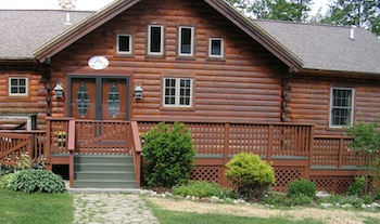 Log home with new door and deck railing